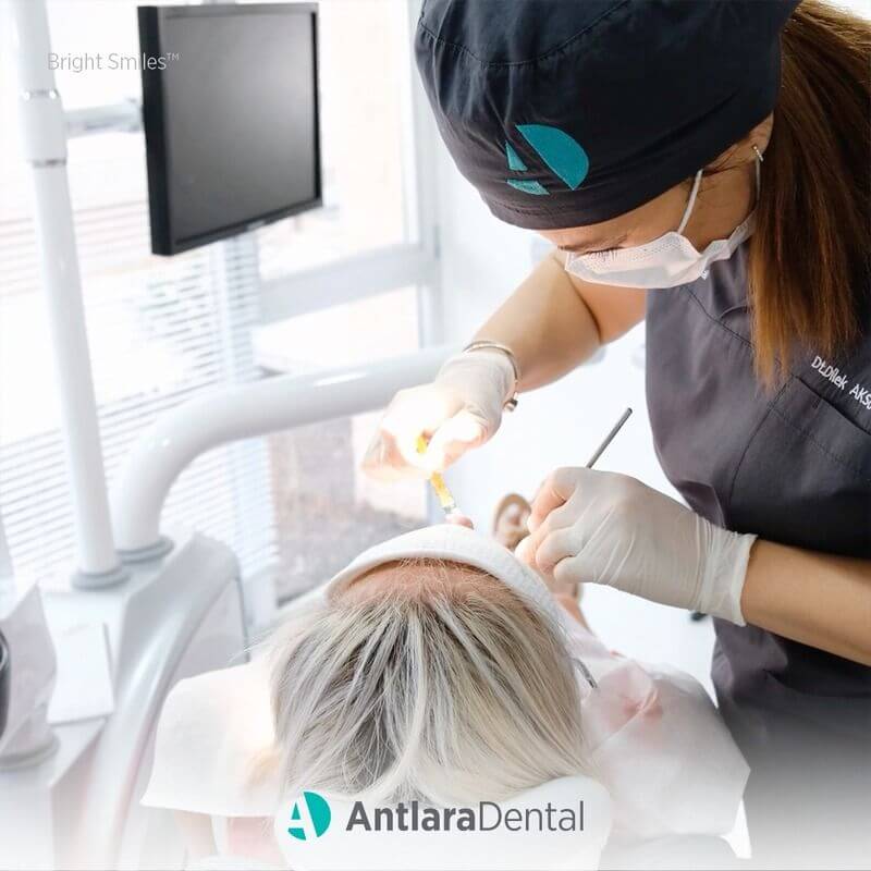 dentist carry out cosmetic dentistry operation with patient in Antalya